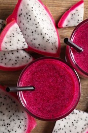 Photo of Delicious pitahaya smoothie and fresh fruits on table, flat lay
