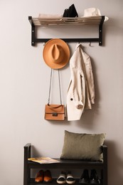 Photo of Hallway interior with stylish furniture, clothes and accessories