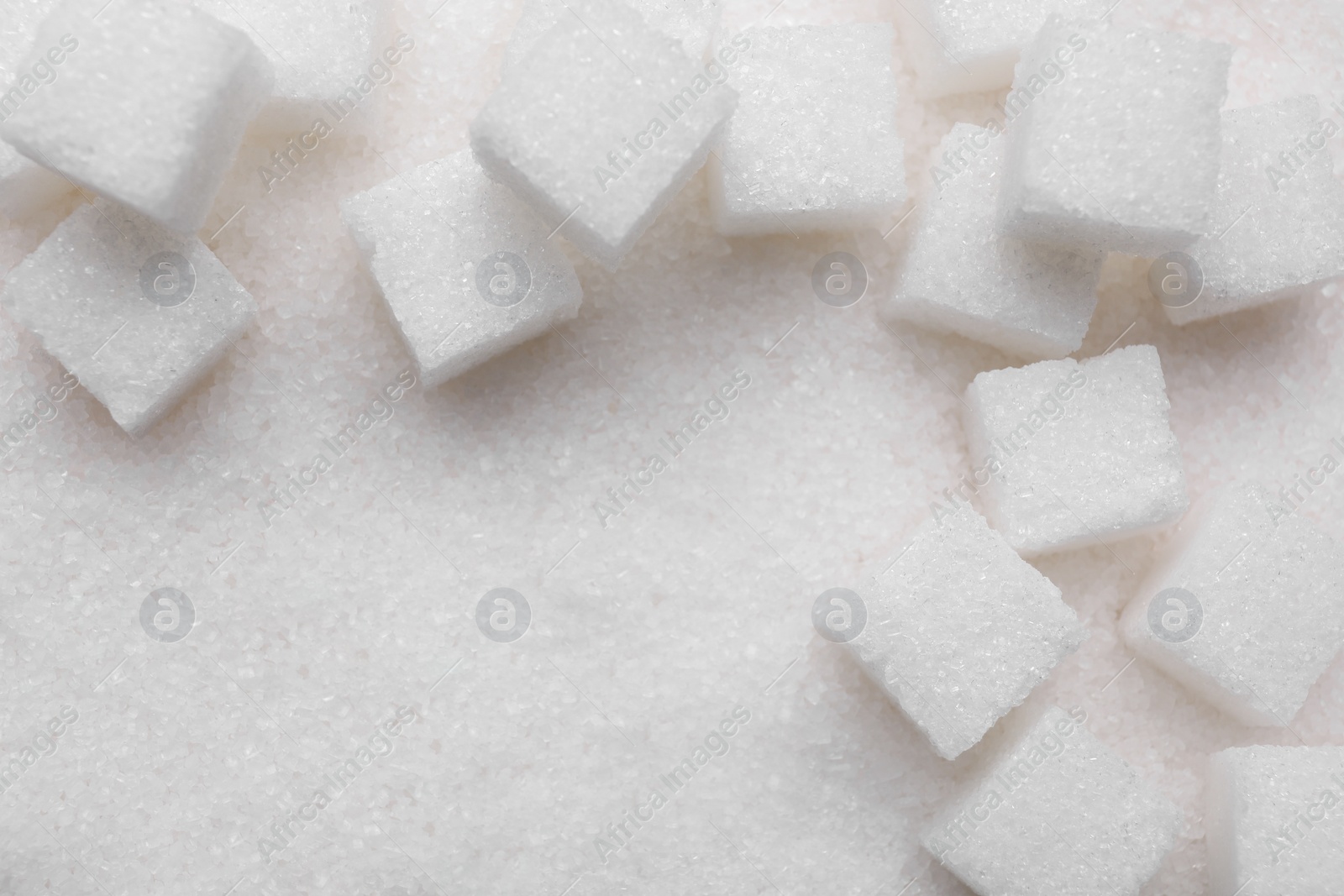 Photo of Different types of white sugar as background, top view