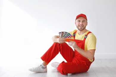 Male decorator with color palette indoors