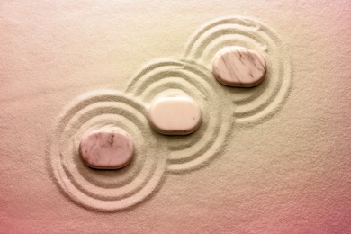 Image of Stones on sand with pattern, flat lay. Zen, meditation, harmony