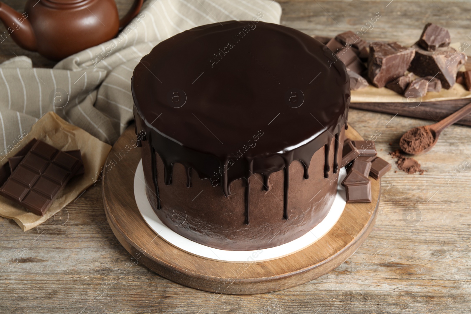 Photo of Freshly made delicious chocolate cake on wooden table