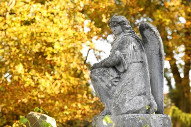Photo of Beautiful statue of angel at cemetery, space for text