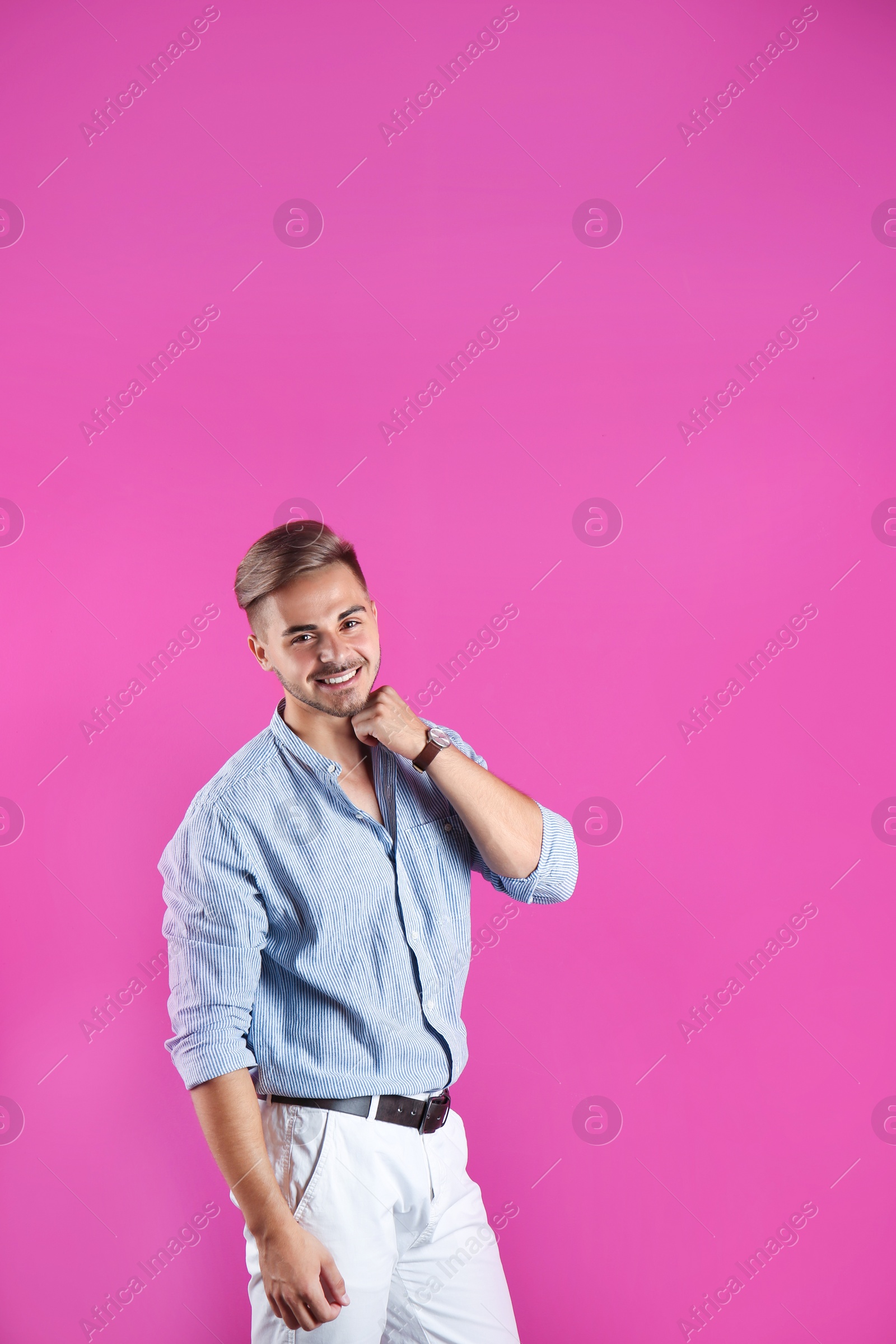 Photo of Young man with trendy hairstyle on color background