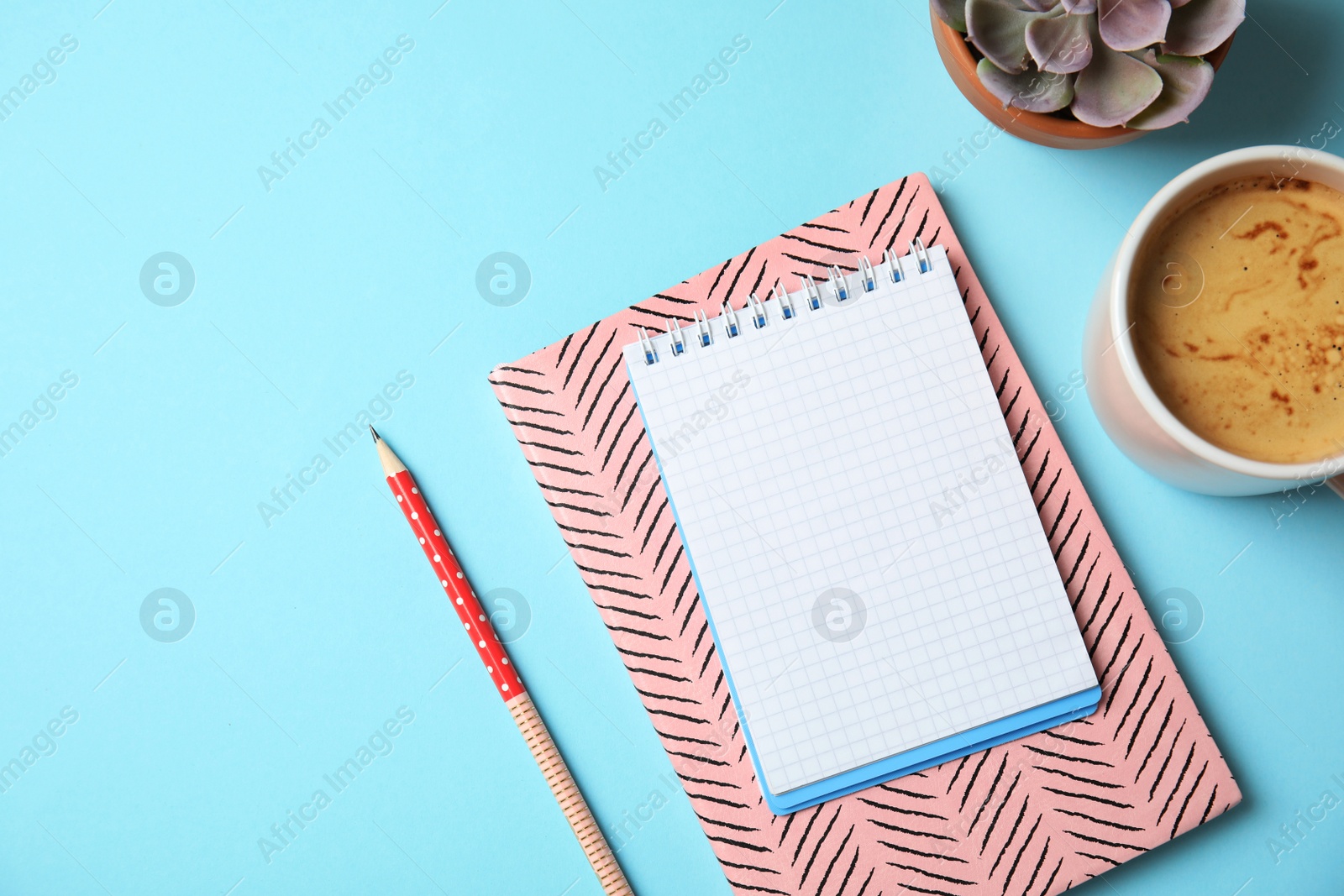 Photo of Flat lay composition with notebooks, coffee and space for text on color background