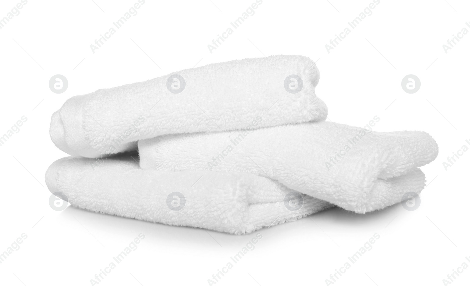 Photo of Folded soft terry towels on white background