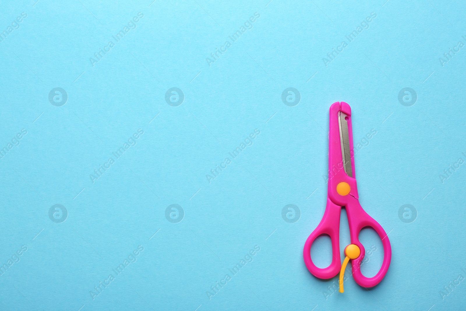 Photo of Training scissors on color background, top view. Space for text