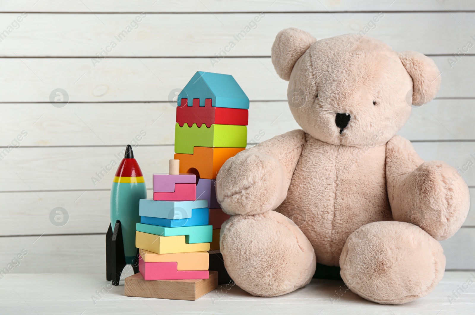 Photo of Set of different toys on white wooden table