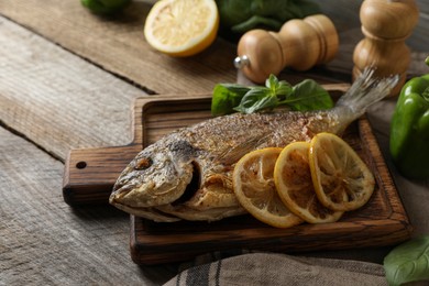 Photo of Delicious dorado fish served on wooden table