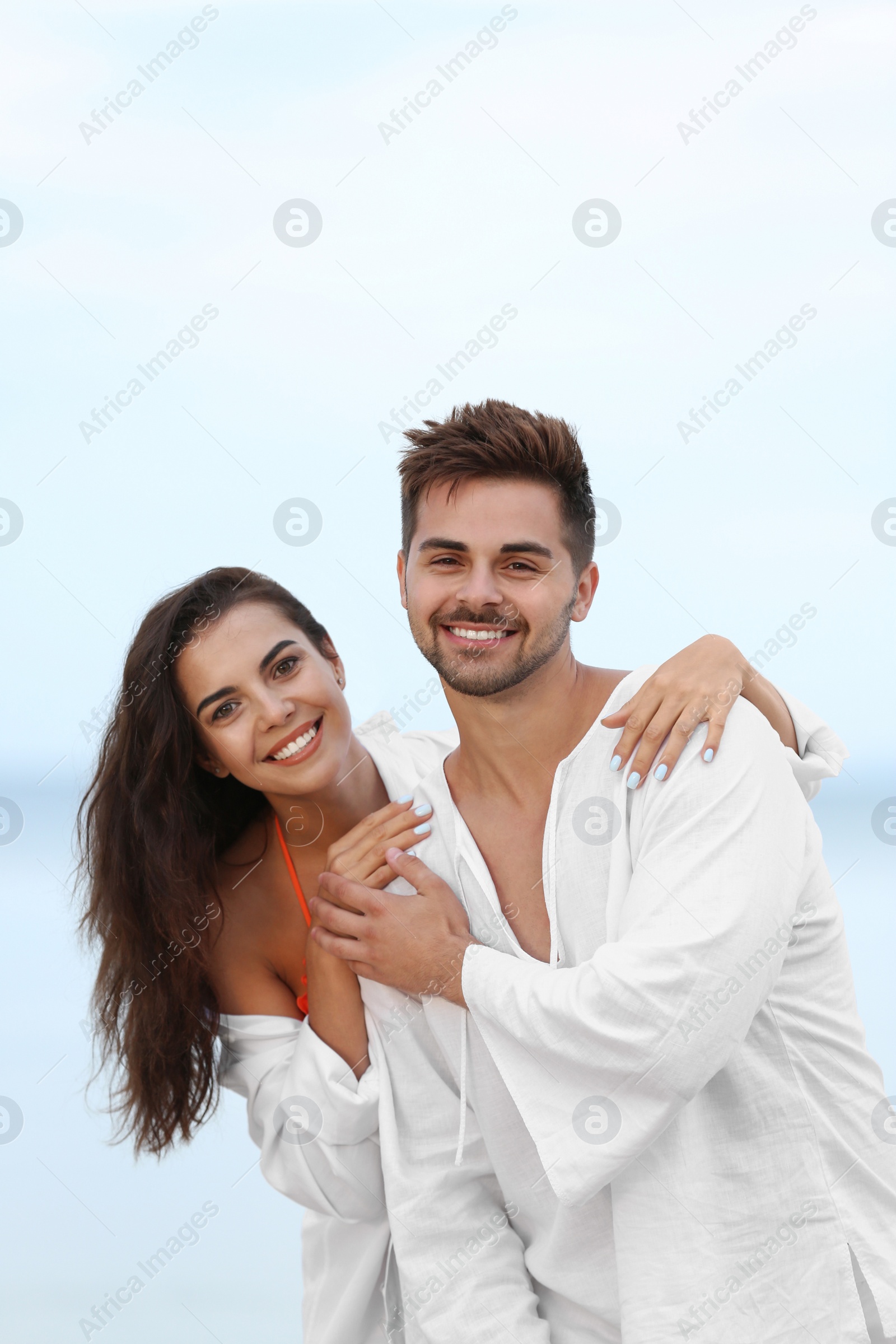 Photo of Happy young couple spending time together on beach