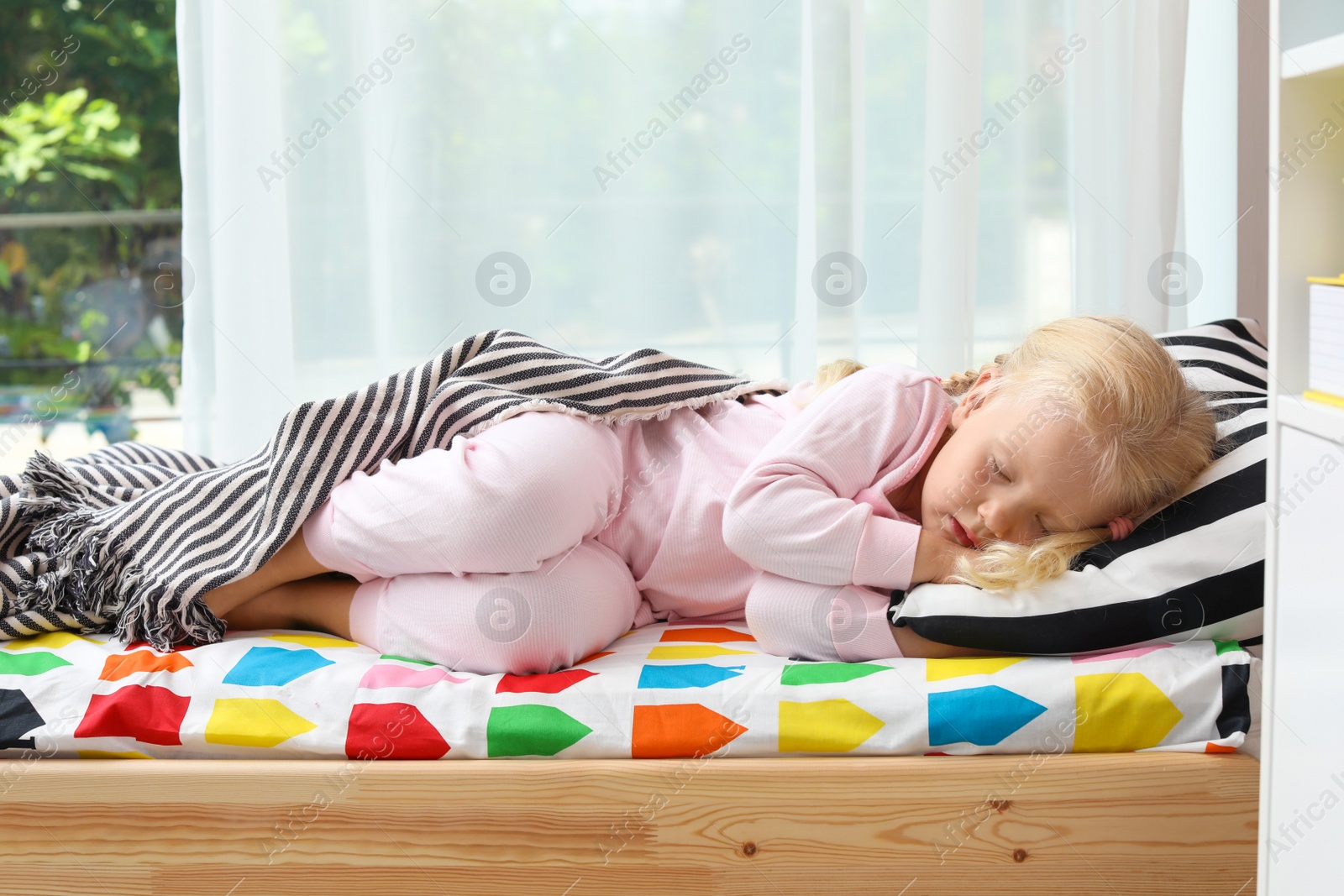 Photo of Cute little girl sleeping in bed at home