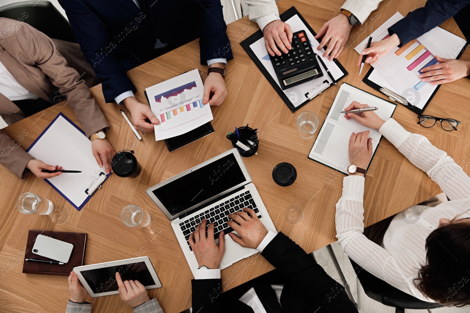 Photo of Businesspeople having meeting at table, top view. Management consulting