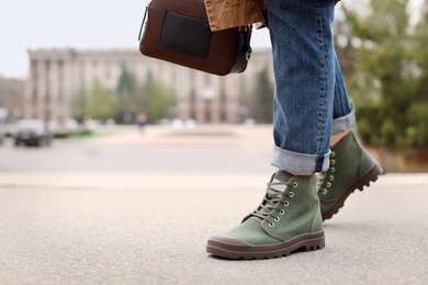 Young woman in comfortable casual shoes walking on street