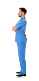 Photo of Full length portrait of smiling male doctor in scrubs isolated on white. Medical staff