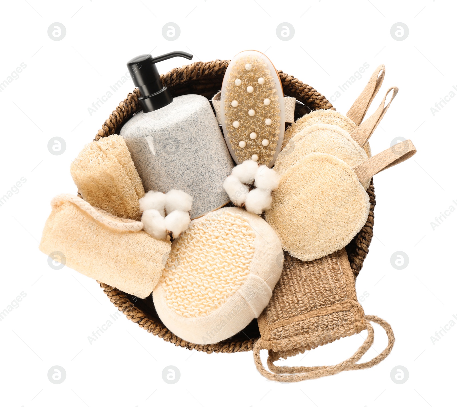 Photo of Set of toiletries with natural loofah sponges in wicker basket isolated on white, top view