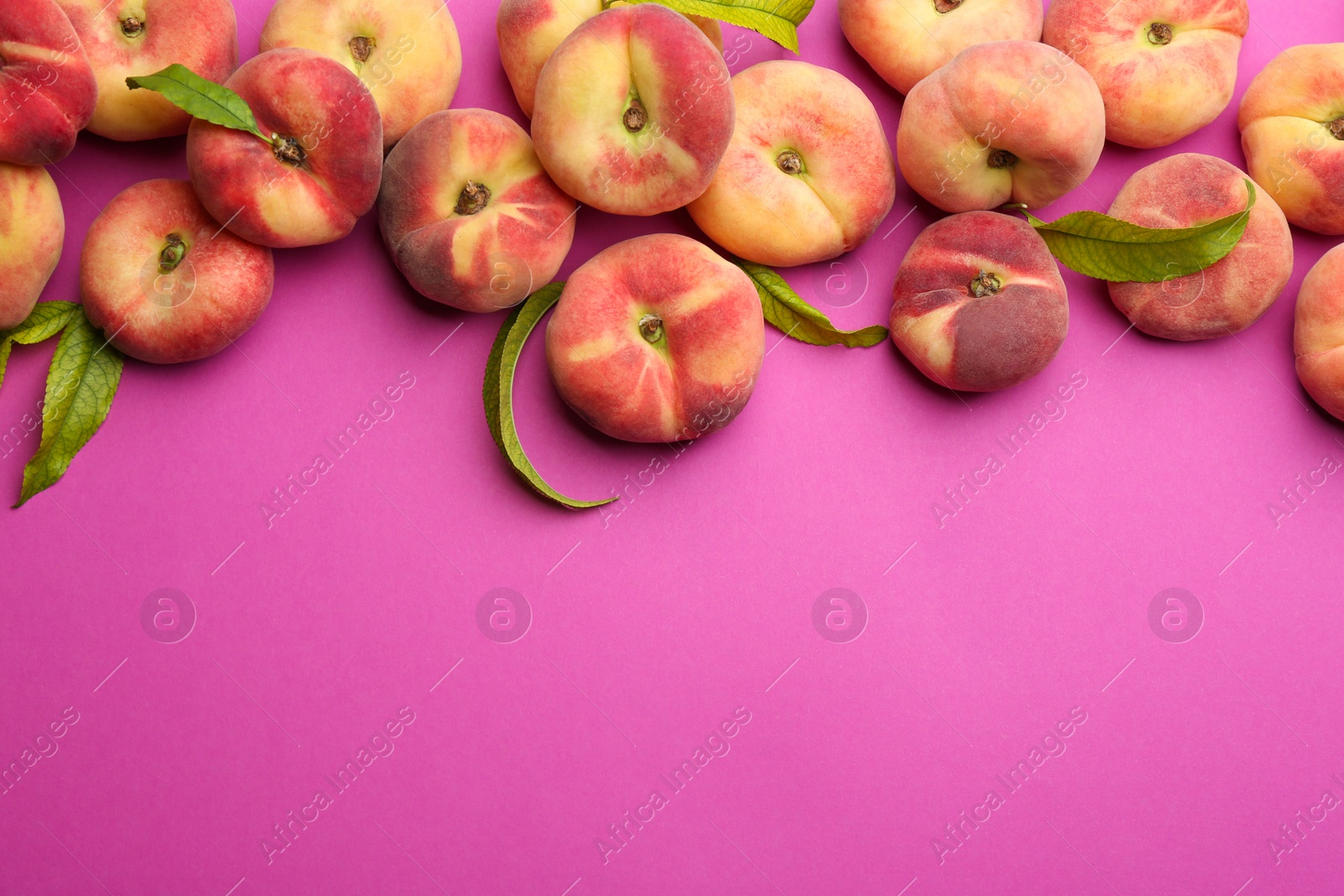 Photo of Fresh donut peaches on pink background, flat lay. Space for text