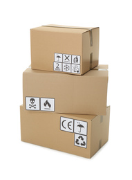 Stack of cardboard boxes with different packaging symbols on white background. Parcel delivery