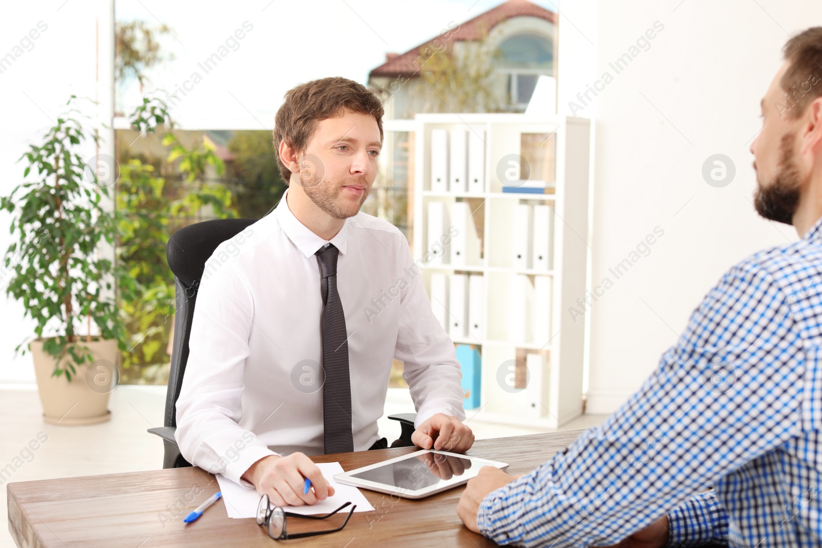 Photo of Human resources manager conducting job interview with applicant in office