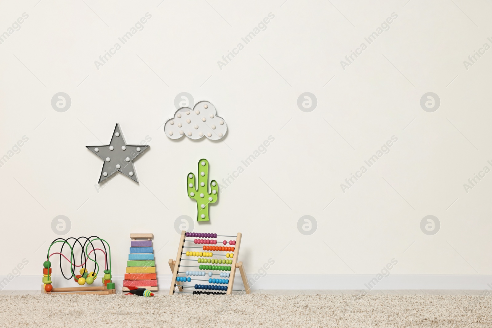 Photo of Educational toys and nightlights in beautiful children's room. Space for text