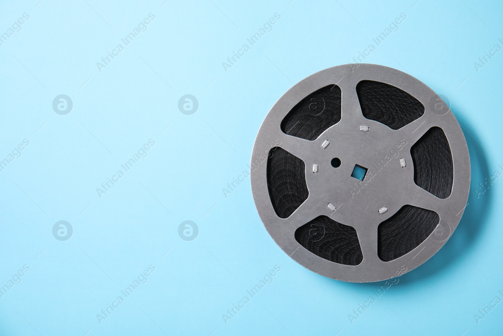 Photo of Movie reel on color background, top view with space for text. Cinema production