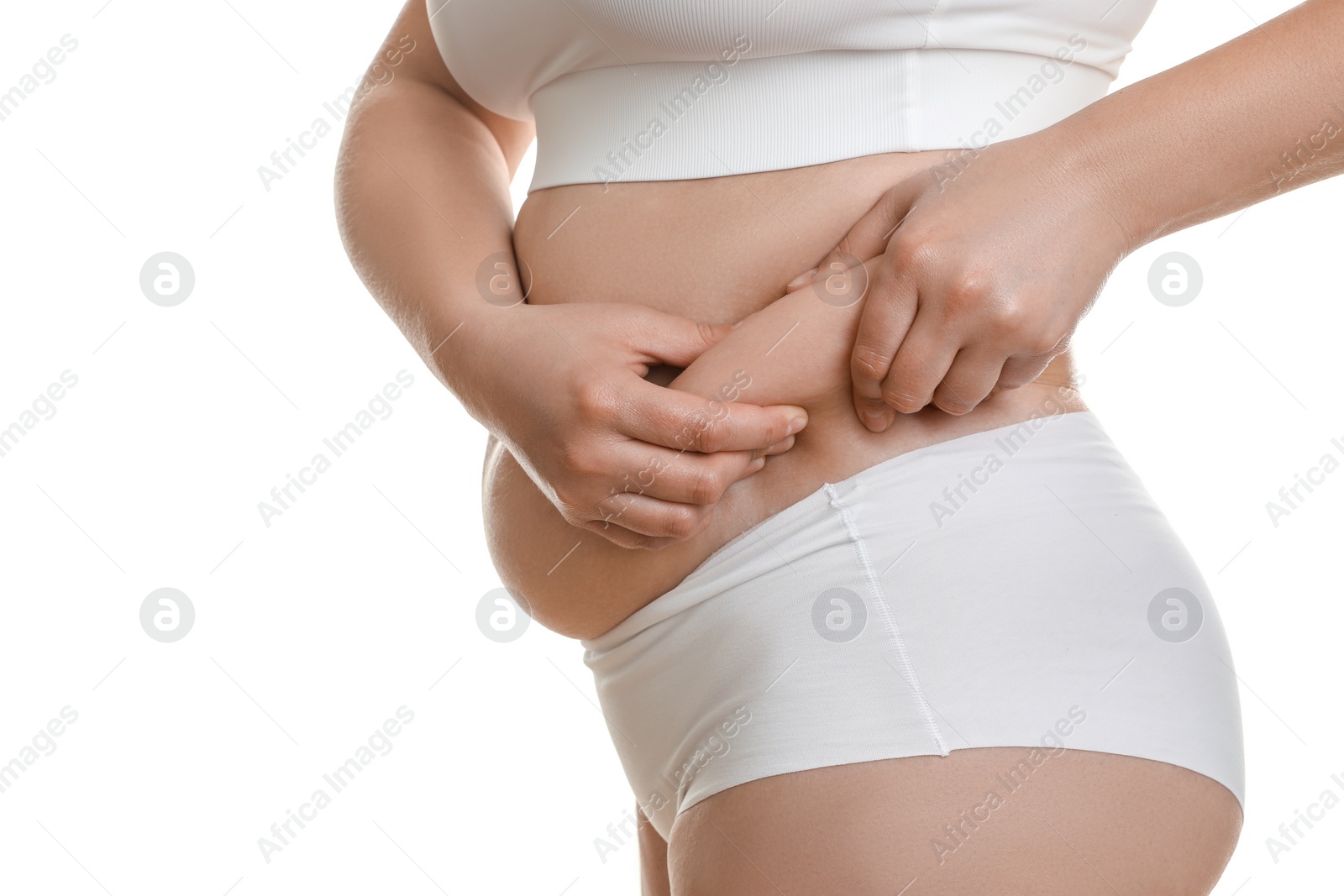 Photo of Woman touching belly fat on white background, closeup. Overweight problem