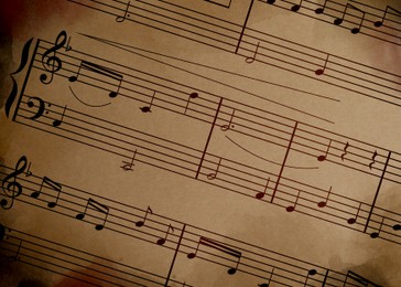 Sheet music. Different musical symbols combined into composition on old paper, closeup