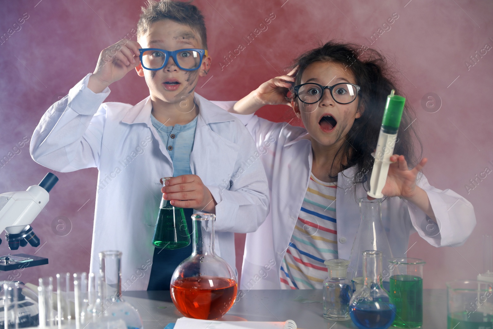 Photo of Children doing chemical research in laboratory. Dangerous experiment