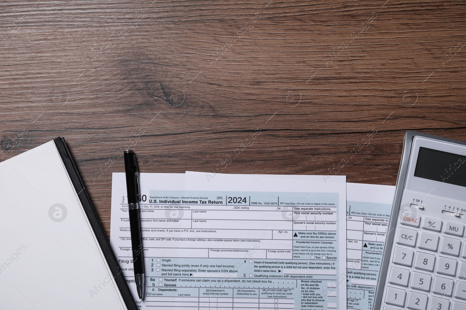 Photo of Payroll. Tax return forms, calculator, notebook and pen on wooden table, flat lay. Space for text