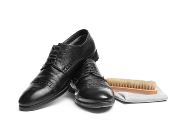 Stylish men's footwear and shoe care accessories on white background