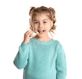 Photo of Cute little girl with Christmas gingerbread cookie on white background