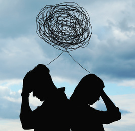 Image of Silhouettes of arguing couple against cloudy sky. Relationship problems
