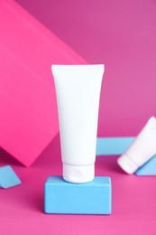 Composition with tubes of hand creams on pink background. Mockup for design