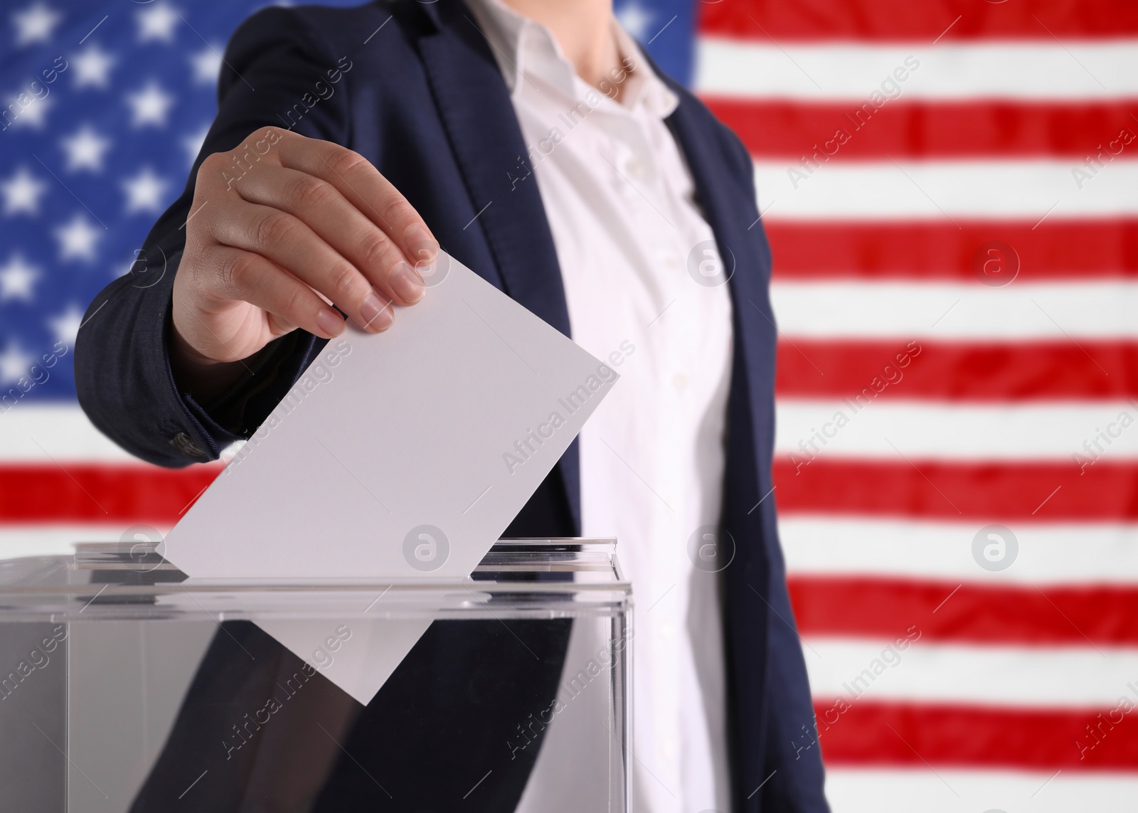 Image of Election in USA. Woman putting her vote into ballot box against national flag of United States, closeup