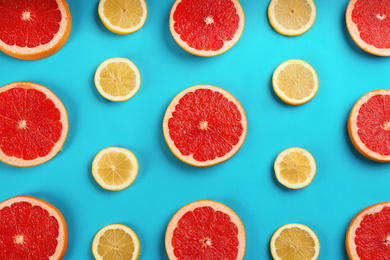 Photo of Flat lay composition with tasty ripe grapefruit slices on blue background