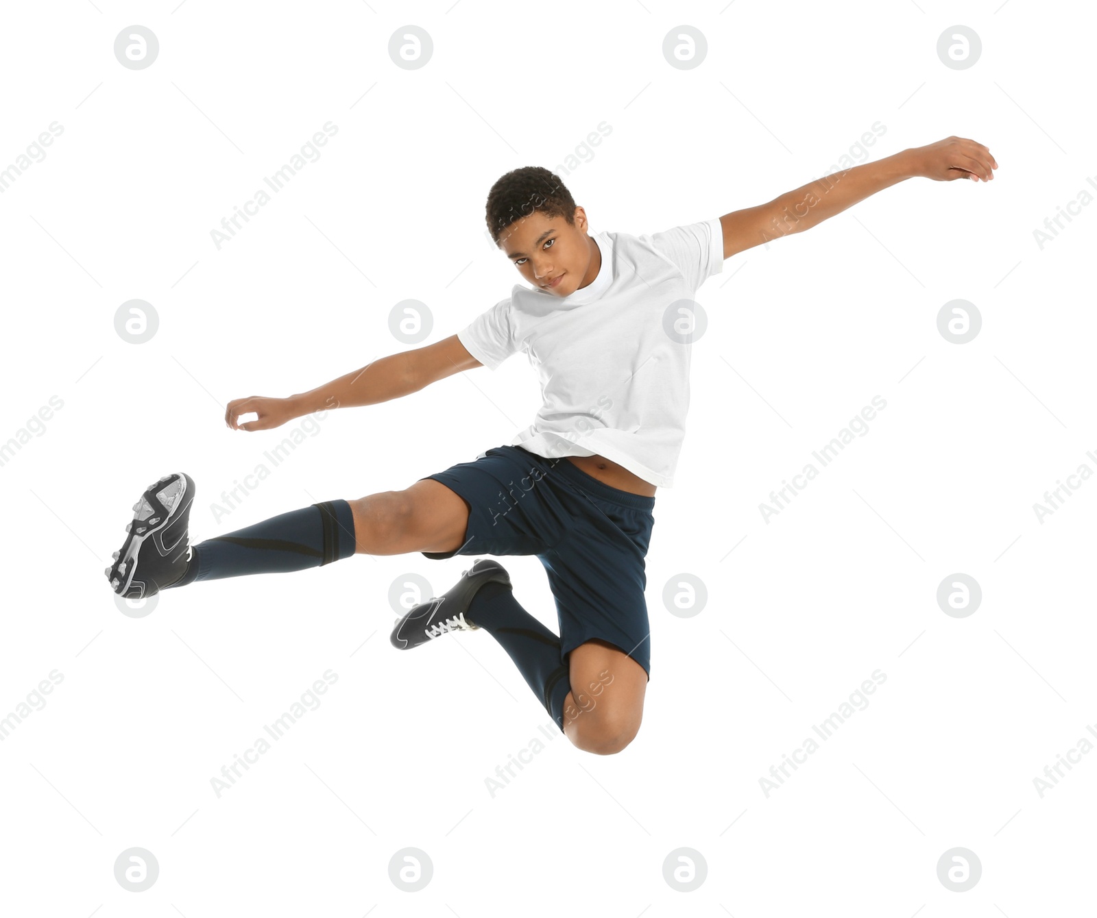 Photo of Teenage African-American boy playing football on white background