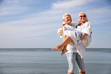 Photo of Mature couple spending time together near sea