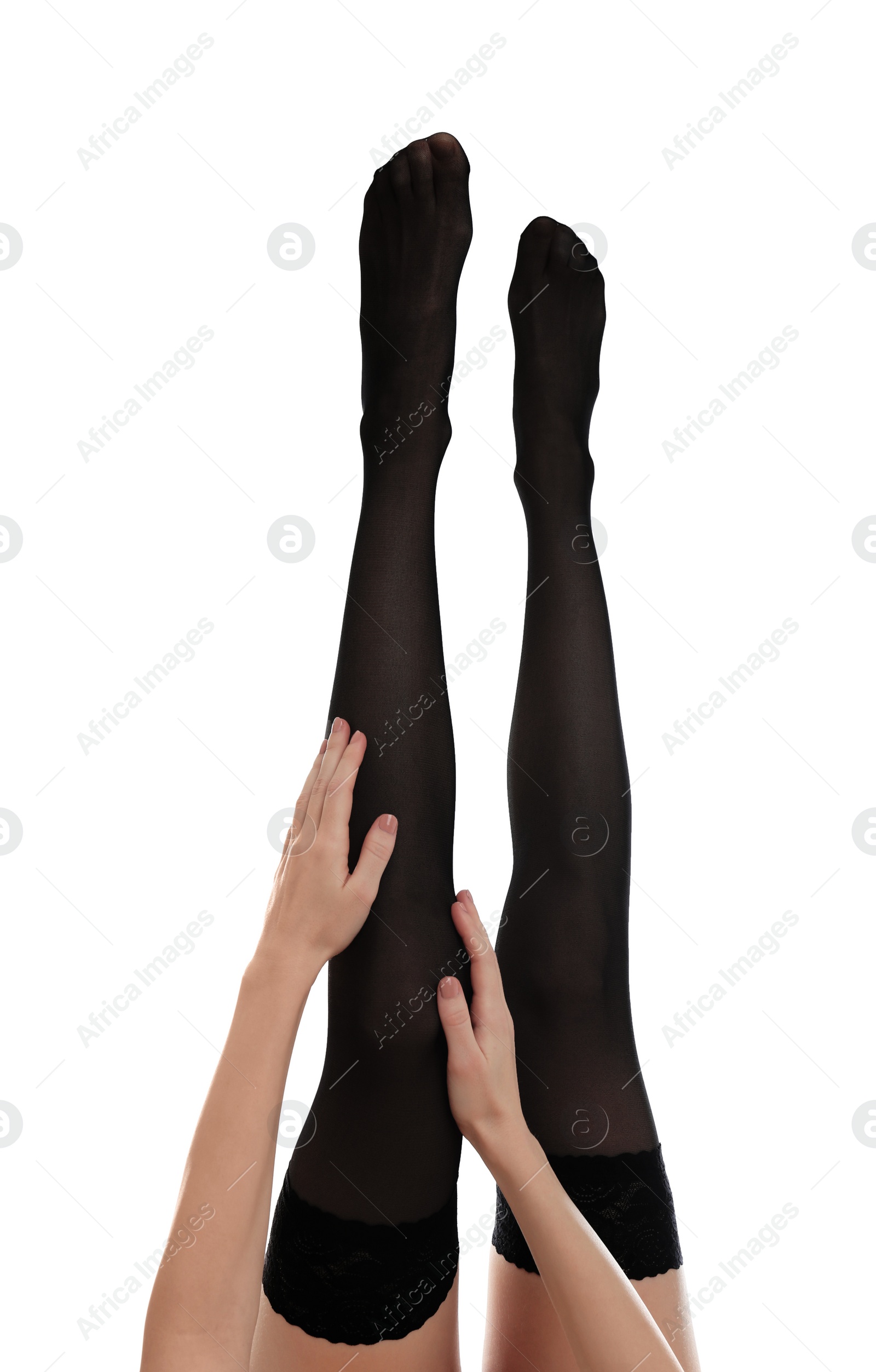 Photo of Young woman putting on stocking against white background, closeup