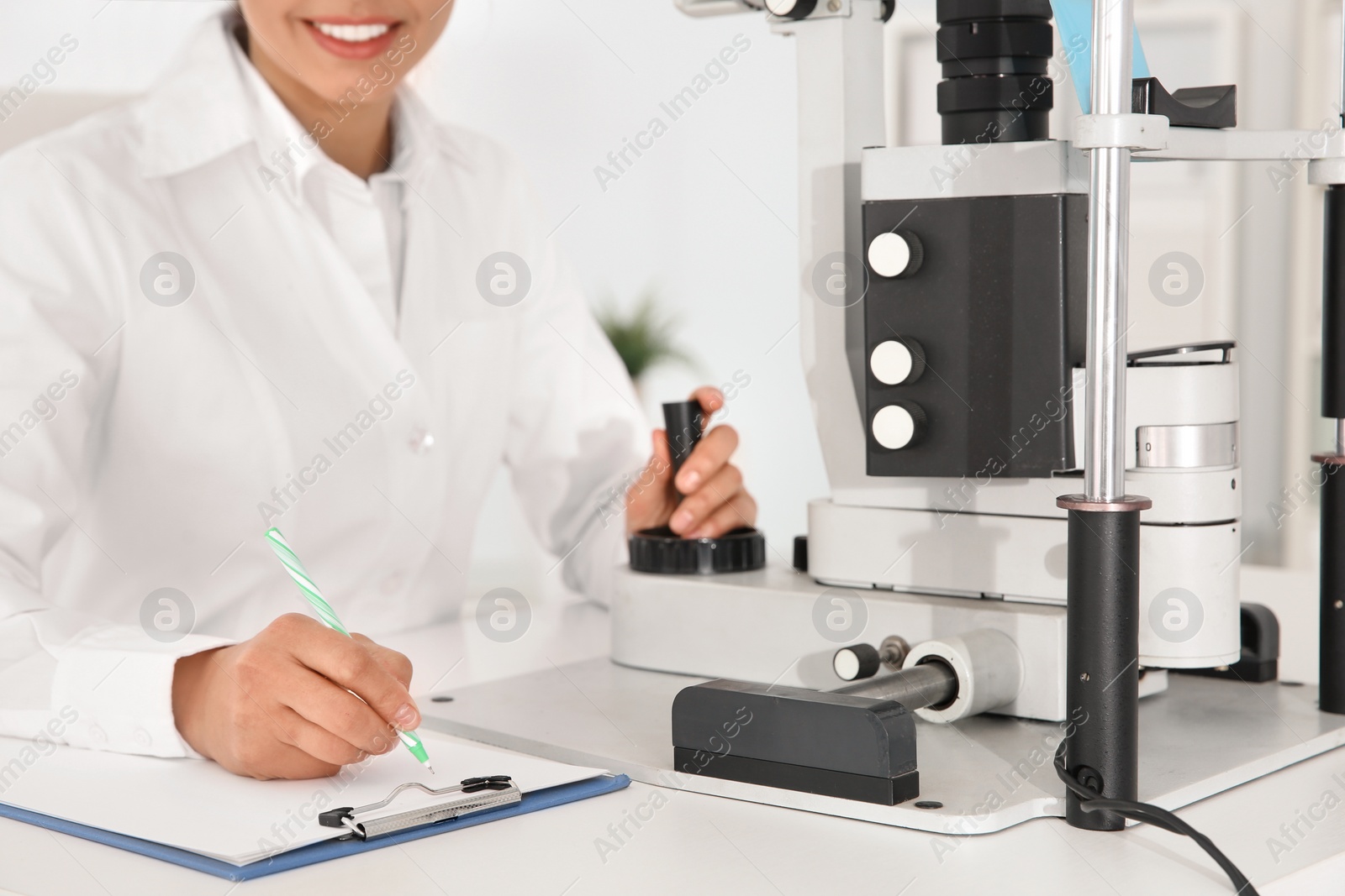 Photo of Female children's doctor with ophthalmic equipment in office, closeup