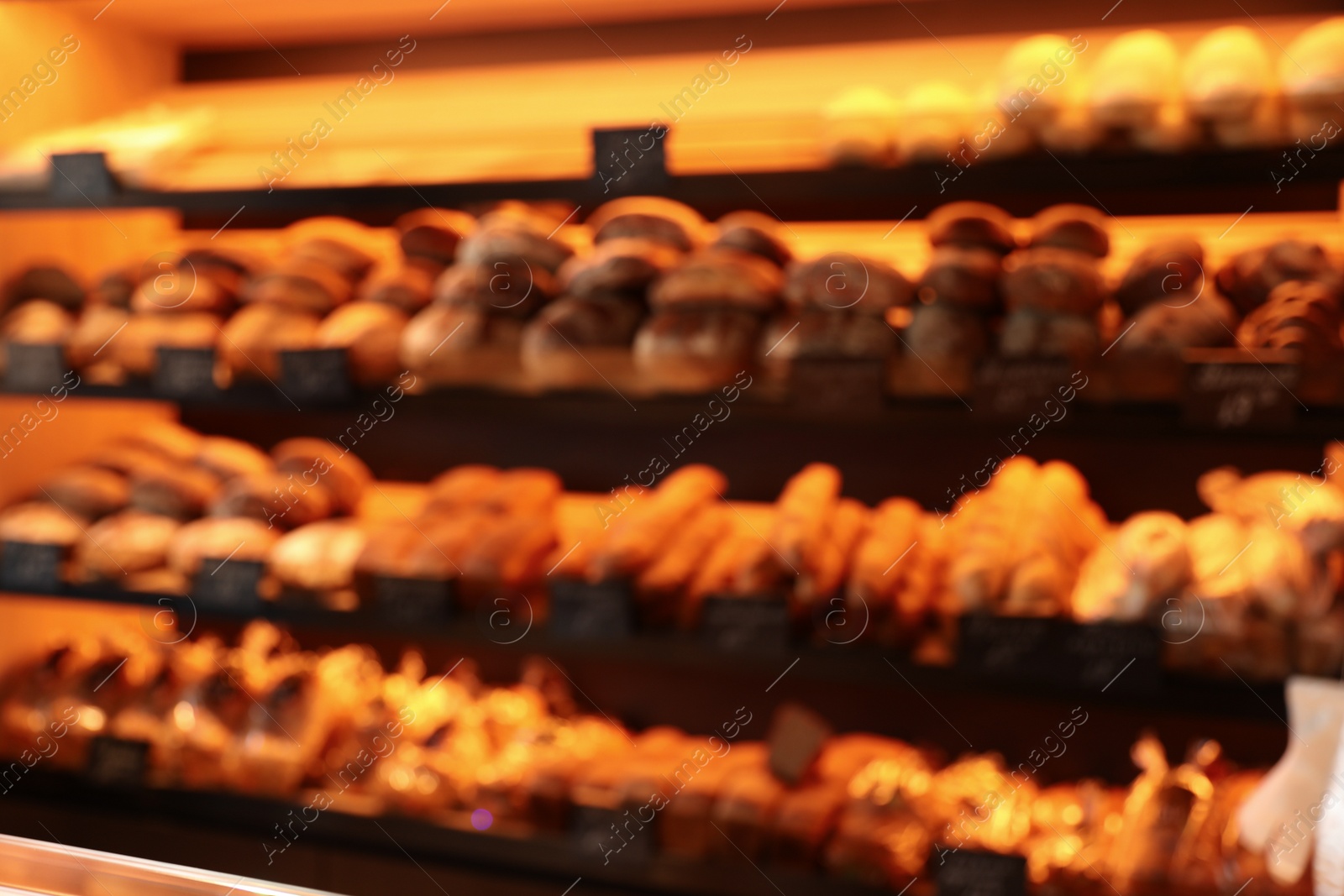 Photo of Blurred view of fresh pastries on counter in bakery store