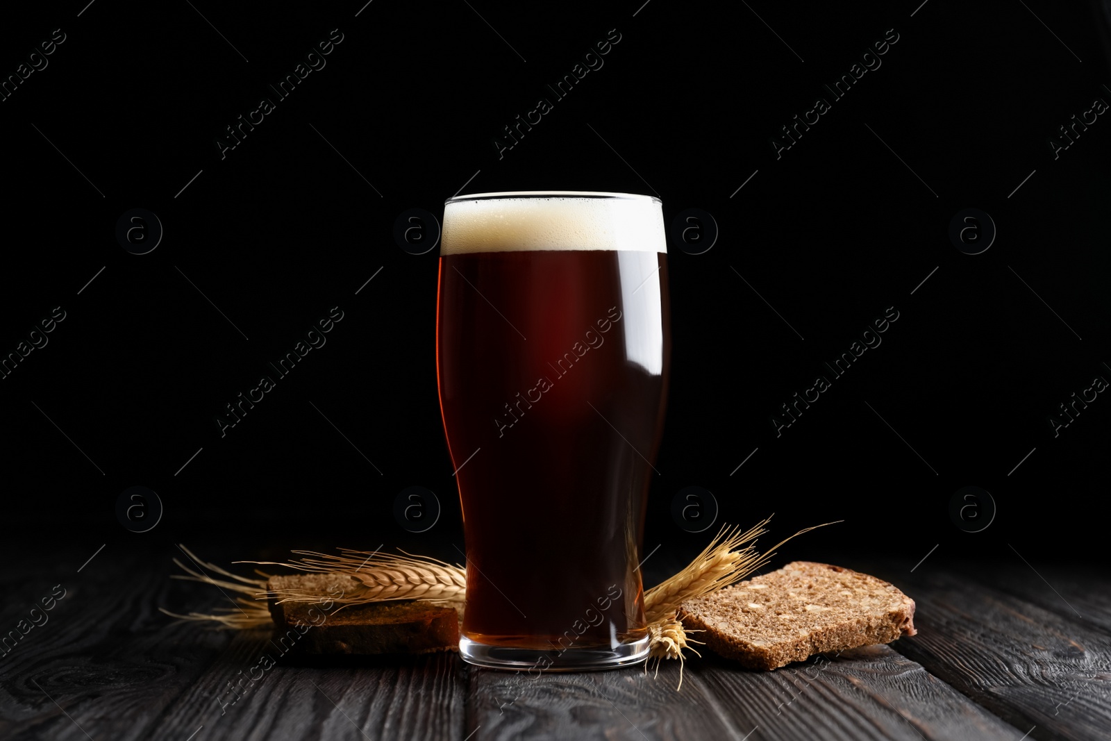 Photo of Delicious kvass, bread and spikes on wooden table