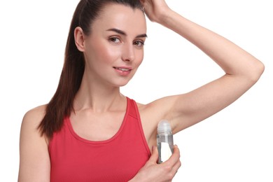 Beautiful woman applying deodorant on white background