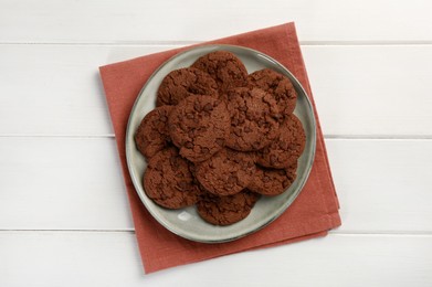 Photo of Delicious chocolate chip cookies on white wooden table, top view