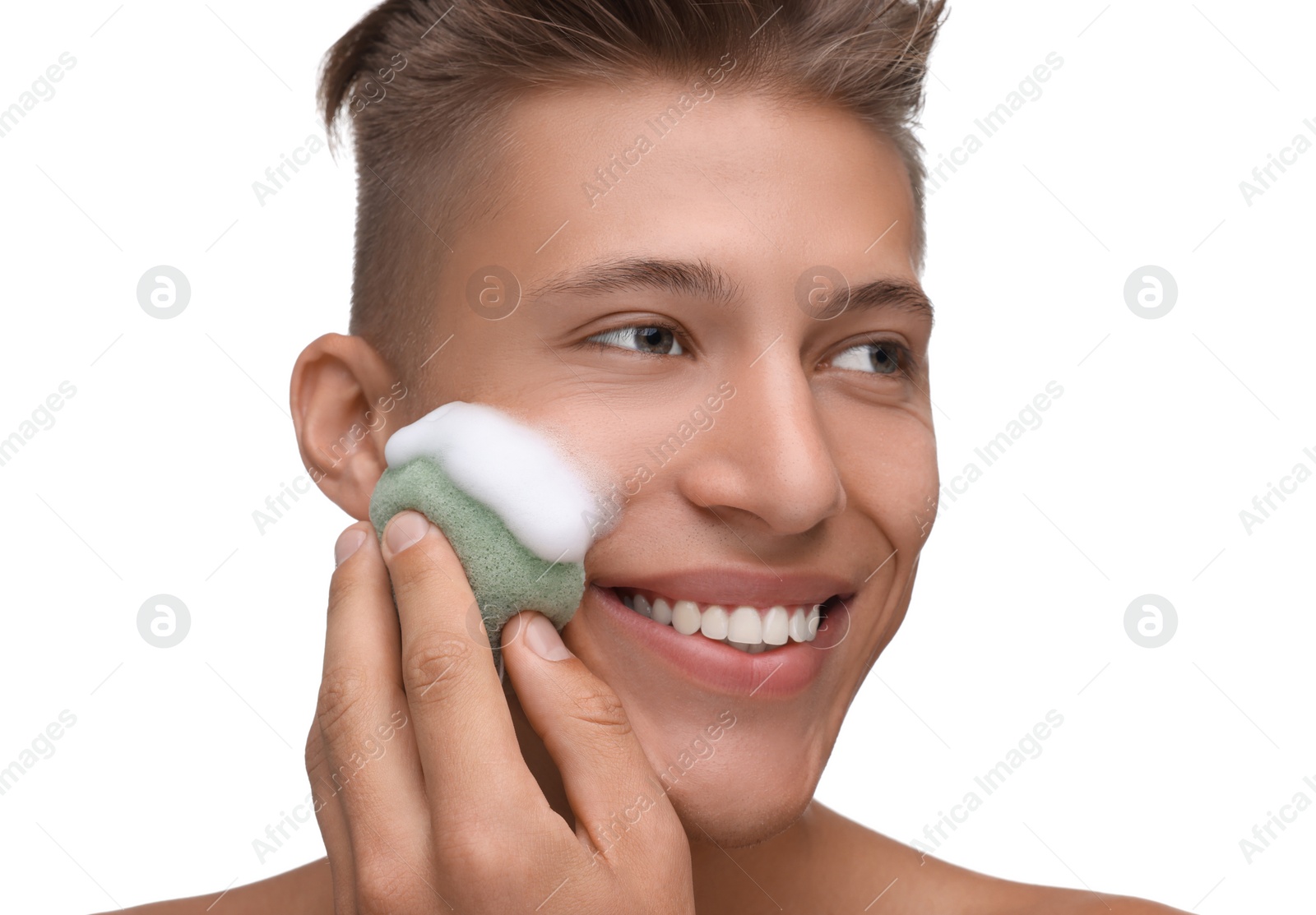 Photo of Happy young man washing his face with sponge on white background