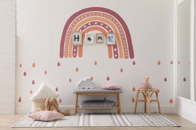 Photo of Child's room interior with rainbow painting on wall