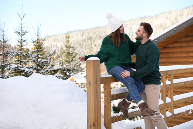 Lovely couple walking together on snowy day. Winter vacation