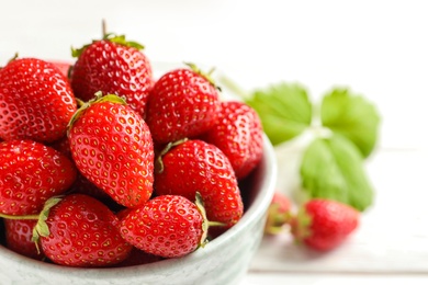 Photo of Bowl with fresh ripe strawberries on table, closeup