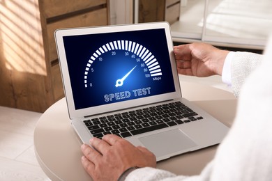Image of Speed test. Man using laptop at table, closeup