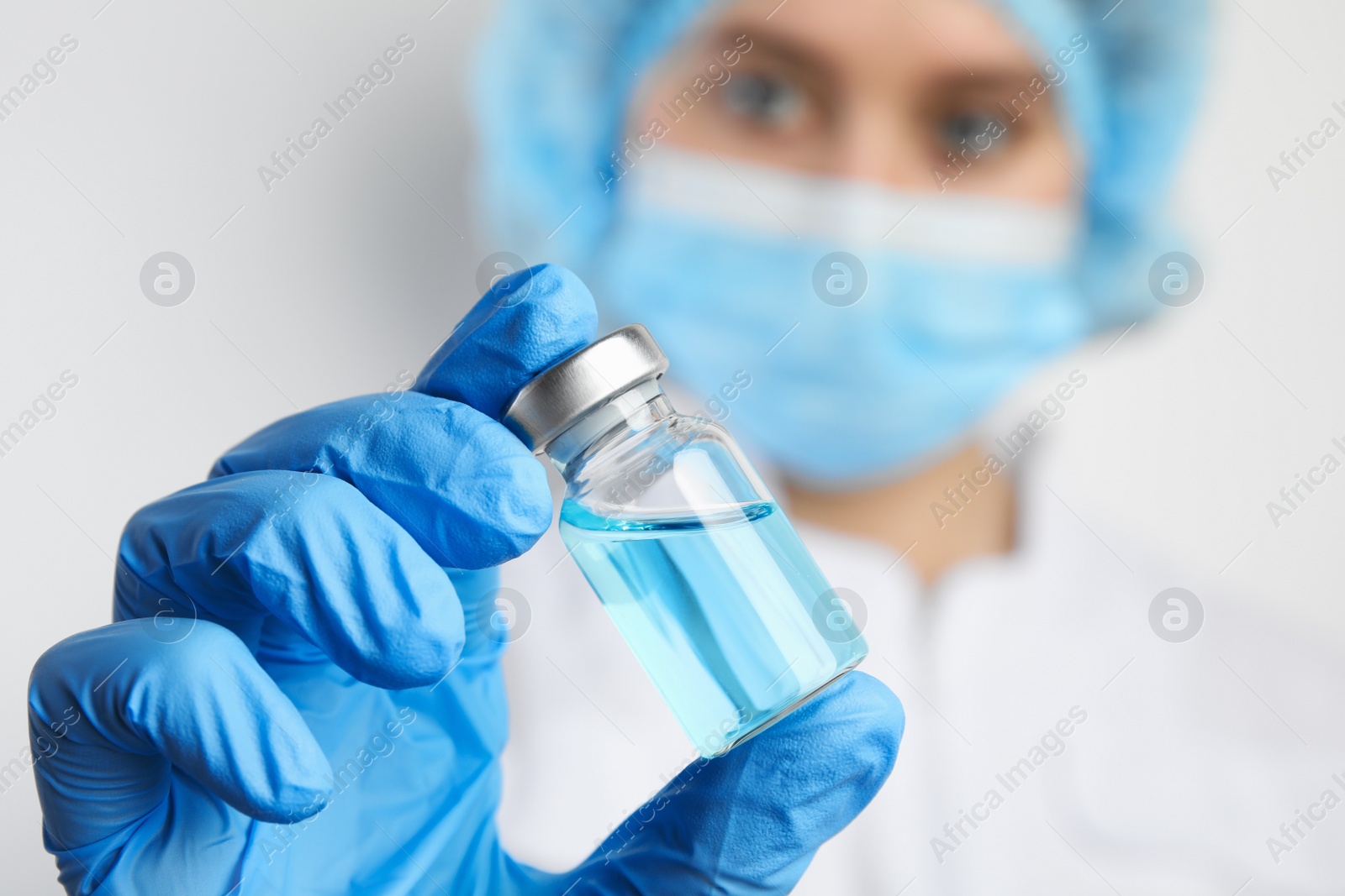 Photo of Doctor holding vial with medication, closeup. Vaccination and immunization