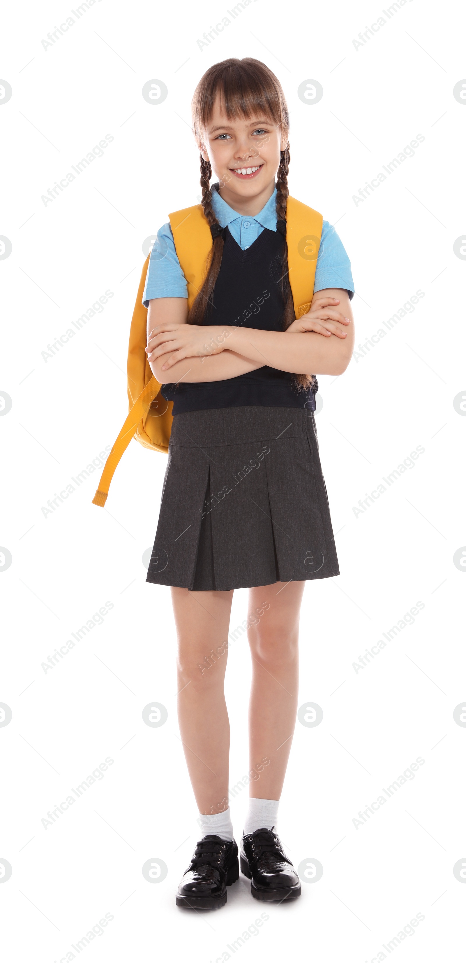 Photo of Full length portrait of cute girl in school uniform with backpack on white background