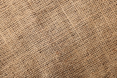 Texture of natural burlap fabric as background, top view